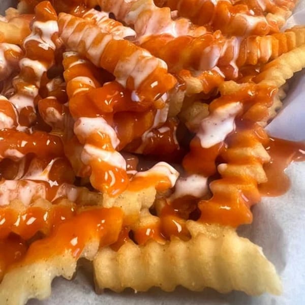 WattaBun's crinkle-cut fries generously topped with orange buffalo sauce and white ranch dressing.